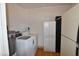 Laundry room with washer, dryer, water heater, fridge, and built-in cabinets at 5720 E University Dr, Mesa, AZ 85205