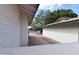 View of the side yard with gravel, white fence, and mature tree at 5720 E University Dr, Mesa, AZ 85205