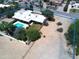 The property features a large flat roof, desert landscaping and mature trees and a private backyard swimming pool at 5905 E Donna Ln, Paradise Valley, AZ 85253