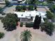 Expansive aerial view of a home showcasing its desert landscaping, pool, and spacious layout with a defined property line at 5905 E Donna Ln, Paradise Valley, AZ 85253