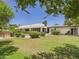 Expansive backyard featuring lush green grass, mature trees, and a pristine pool at 5905 E Donna Ln, Paradise Valley, AZ 85253