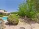 Secluded backyard with mature trees, in-ground pool, brick patio, and lush landscaping at 5905 E Donna Ln, Paradise Valley, AZ 85253