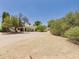 Wide-angle view of a desert home's exterior, highlighting the natural landscape and architectural facade of the residence at 5905 E Donna Ln, Paradise Valley, AZ 85253