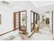 Hallway featuring glass doors and tiled floors, offering seamless transitions between interior spaces at 5905 E Donna Ln, Paradise Valley, AZ 85253
