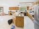 Bright kitchen boasts a large island, ample counter space, stainless steel appliances and natural light from the window at 5905 E Donna Ln, Paradise Valley, AZ 85253