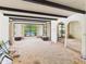 Open-concept living area showcases beamed ceilings, expansive windows, and a view of the sparkling backyard pool at 5905 E Donna Ln, Paradise Valley, AZ 85253