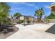 Backyard featuring a covered patio, mature trees, and block wall at 6546 E Dallas St, Mesa, AZ 85205
