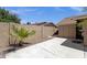 Private backyard featuring concrete patio, block wall, and verdant palm tree at 6546 E Dallas St, Mesa, AZ 85205
