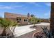 A spacious backyard with a concrete patio, desert landscaping and a brown house at 6546 E Dallas St, Mesa, AZ 85205