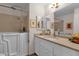 Accessible bathroom featuring a walk-in tub, vanity with neutral countertops, and a framed mirror at 6546 E Dallas St, Mesa, AZ 85205