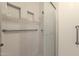 Accessible bathroom with white tile, a glass shower door, and supportive grab bars at 6546 E Dallas St, Mesa, AZ 85205