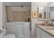 Neutral bathroom featuring a walk-in tub, a shower with adjustable bars, and a vanity with framed mirrors at 6546 E Dallas St, Mesa, AZ 85205