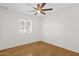 Bedroom with light wood flooring, a ceiling fan and natural light from window at 6546 E Dallas St, Mesa, AZ 85205