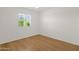 Sunny bedroom features light wood floors, ceiling fan and a view to the backyard at 6546 E Dallas St, Mesa, AZ 85205