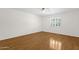 Bright and airy bedroom with laminate floors, ceiling fan and a sunny window at 6546 E Dallas St, Mesa, AZ 85205