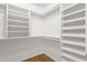 Walk-in closet with built-in shelves and wood flooring at 6546 E Dallas St, Mesa, AZ 85205