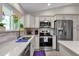 Bright kitchen featuring stainless steel appliances, stone countertops, and backsplash at 6546 E Dallas St, Mesa, AZ 85205