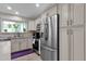 Well-lit kitchen with stainless steel appliances, neutral cabinets, and a large sink under the window at 6546 E Dallas St, Mesa, AZ 85205