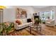 Bright living room with hardwood floors, modern furniture, and large windows offering plenty of natural light at 6546 E Dallas St, Mesa, AZ 85205