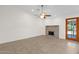 Cozy living room featuring a decorative fireplace, tiled floors and access to patio at 6546 E Dallas St, Mesa, AZ 85205