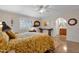 Bedroom with hardwood floors, a bed with floral bedding, and ample natural light at 6546 E Dallas St, Mesa, AZ 85205