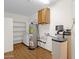 Clean utility room featuring a water heater, water softener, cabinets, and shelving at 6546 E Dallas St, Mesa, AZ 85205