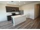 Modern kitchen featuring an island, stainless steel appliances, and dark wood cabinetry at 658 S Maricopa Rd, Florence, AZ 85132