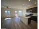 Bright, open-concept living area with a kitchen island, lots of natural light, and wood flooring at 658 S Maricopa Rd, Florence, AZ 85132