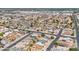 Extensive aerial shot of a residential area with the community layout, roadways, and some desert in the distance at 6938 W Nicolet Ave, Glendale, AZ 85303