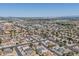 An aerial view displaying the community's layout, roadways, and the desert landscape off in the distance at 6938 W Nicolet Ave, Glendale, AZ 85303