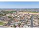 Expansive aerial shot of a residential area, capturing the community layout, roadways, and surrounding desert landscape at 6938 W Nicolet Ave, Glendale, AZ 85303