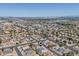An aerial view displaying the community's layout, roadways, the desert landscape and identifying a residence location at 6938 W Nicolet Ave, Glendale, AZ 85303