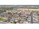 Expansive aerial shot of a residential area, capturing the community layout, roadways, and a pinpoint location at 6938 W Nicolet Ave, Glendale, AZ 85303