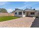 Backyard with brick patio and artificial grass for low maintenance at 6938 W Nicolet Ave, Glendale, AZ 85303