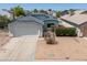 Charming single-story home with a two-car garage and low maintenance desert landscaping in front yard at 6938 W Nicolet Ave, Glendale, AZ 85303
