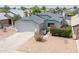 Charming single-story home with a two-car garage and low maintenance desert landscaping in front yard at 6938 W Nicolet Ave, Glendale, AZ 85303