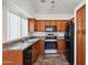 Kitchen featuring dark wood cabinets, stainless steel appliances, and tile flooring at 6938 W Nicolet Ave, Glendale, AZ 85303