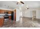 Open concept living space flowing into a kitchen area with dark wood cabinets at 6938 W Nicolet Ave, Glendale, AZ 85303