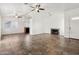 Expansive living space featuring neutral tile floors, a fireplace, and a ceiling fan at 6938 W Nicolet Ave, Glendale, AZ 85303