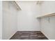 Walk-in closet with gray tile flooring and clothes hanging bars at 6938 W Nicolet Ave, Glendale, AZ 85303