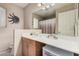Bathroom featuring a single sink vanity with storage, a large mirror, and a shower and tub combo at 7426 W Cholla St, Peoria, AZ 85345