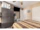 Bedroom featuring wood-look floors, ceiling fan, a queen bed, and built in wardrobe at 7426 W Cholla St, Peoria, AZ 85345