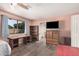 Bedroom features a window with a view, wood-look floors, and access to an ensuite bathroom at 7426 W Cholla St, Peoria, AZ 85345