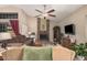 Cozy living room with a brick fireplace, comfortable seating, and a large window for natural light at 7426 W Cholla St, Peoria, AZ 85345