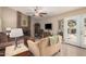 Cozy living room with brick fireplace, ceiling fan, neutral tones, and sliding doors to the backyard at 7426 W Cholla St, Peoria, AZ 85345