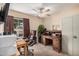 Home office featuring a desk, leather rolling chair, window, and ample storage space at 7426 W Cholla St, Peoria, AZ 85345
