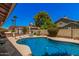 Inviting backyard pool with lush landscaping and clear blue water, great for relaxation and enjoyment at 7426 W Cholla St, Peoria, AZ 85345