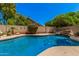 Beautiful backyard pool with a rock waterfall feature and privacy landscaping, perfect for a serene retreat at 7426 W Cholla St, Peoria, AZ 85345
