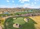 Scenic aerial view of golf course, lake, and mountains in the distance at 7846 E Wilderness Trl, Gold Canyon, AZ 85118