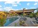 Beautiful backyard with pool, mature cacti, covered patio, and desert landscape at 7846 E Wilderness Trl, Gold Canyon, AZ 85118